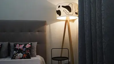 a lamp in a bedroom next to a bed at Cozy studio with a sea view in Nice