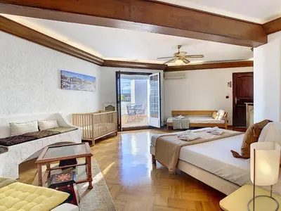a bedroom with a bed and a living room with a couch at Nestor&Jeeves - BEACH COTTAGE TERRACE - Central - Very close sea - Top floor in Nice