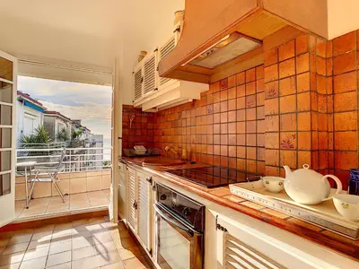 a kitchen with a view of a balcony at Nestor&Jeeves - BEACH COTTAGE TERRACE - Central - Very close sea - Top floor in Nice