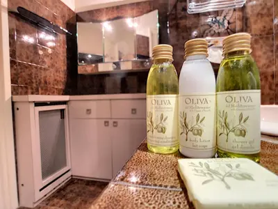 two bottles of olive oil sitting on a counter in a kitchen at Nestor&Jeeves - BEACH COTTAGE TERRACE - Central - Very close sea - Top floor in Nice