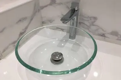 a glass sink with a faucet in a bathroom at Promenade des anglais Amazing sea view 140M2 3BR in Nice