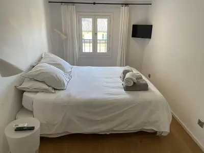 a bedroom with a white bed with towels on it at Homelivia, Lovely One bedroom flat Place GARIBALDI et PORT in Nice