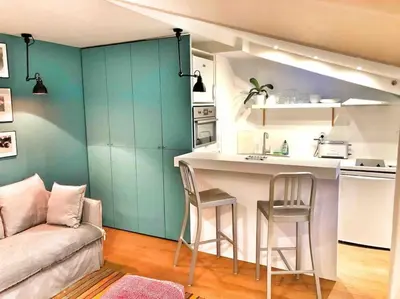 a kitchen with a table and chairs in a room at Homelivia, Lovely One bedroom flat Place GARIBALDI et PORT in Nice
