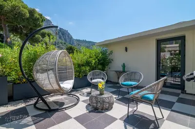a patio with chairs and a table with a view at Appartement Mera Cosy apartment with incredible sea view in Èze