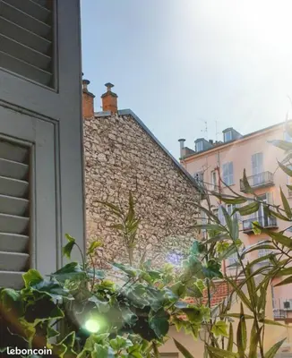 a building with a stone wall and some plants at Wonderful heart of Nice, AC, 15