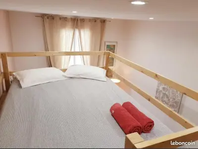 a bed with a red blanket on it in a room at Wonderful heart of Nice, AC, 15