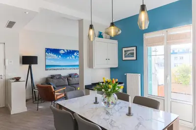 a kitchen and dining room with a table and chairs at La Terrasse du Port AP4212 in Nice