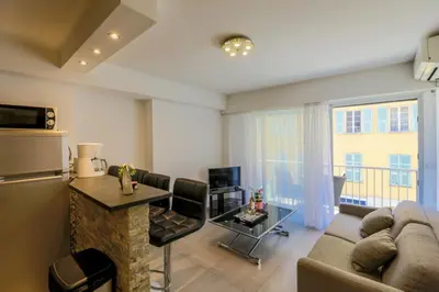 a living room with a couch and a table at SUEDE AP4207 by Riviera Holiday Homes in Nice