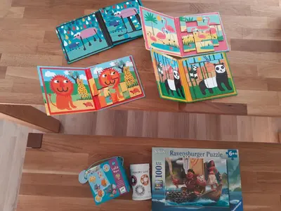 a table with books and other toys on it at Sunny and calm 2 bed apartment place du Pin in Nice
