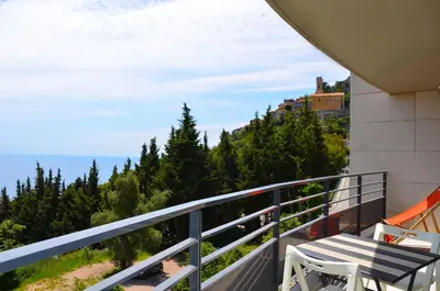 a balcony with a view of the ocean at La Perle d'Eze - Aparthotel in Èze