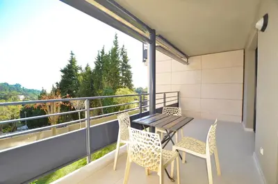 a balcony with a table and chairs and a view at La Perle d'Eze - Aparthotel in Èze