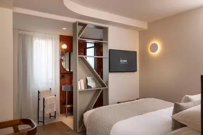 a bedroom with a white bed and a mirror at Ikonik Jean Médecin in Nice