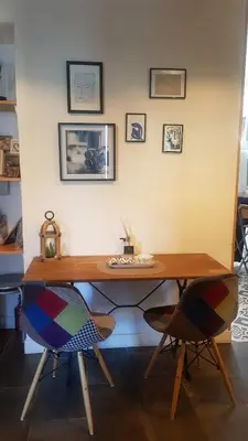 a wooden desk with two chairs in a room at Moderne, 2 chambres, 6 Couchages, EASY CHECK-IN in Nice
