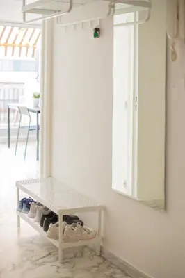 a white table with shoes on a shelf in a room at Studio with terrace and sea view, 10 min to the beach in Nice