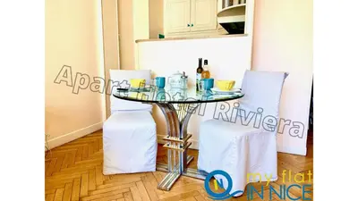 a glass table in a kitchen with two chairs at ApartHotel Riviera - Hyper Centre Ville - Studio Supérieur AC avec balcon et aperçu mer - BALCON MASSENET 1 in Nice