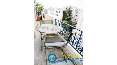 a balcony of a apartment with a tablehov entrance at ApartHotel Riviera - Hyper Centre Musiciens - Superior 1 Bedroom Apartement AC - Balcony - 10 mn Promenade des Anglais - BALCON PALAIS EXCELSIOR 1 in Nice