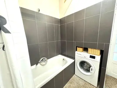 a bathroom with a washing machine and a washer at ApartHotel Riviera - Hyper Centre Musiciens - Superior 1 Bedroom Apartement AC - Balcony - 10 mn Promenade des Anglais - BALCON PALAIS EXCELSIOR 1 in Nice