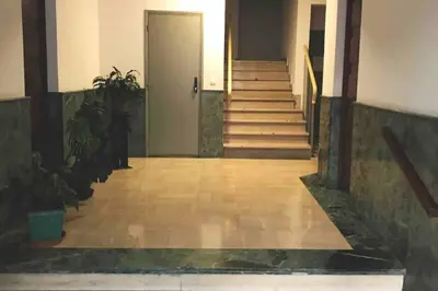 a hallway with stairs and a door in a building at Garibaldi 3 chambres 6 couchages, EASY CHECK-IN in Nice