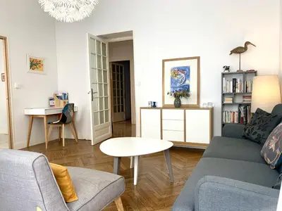 a living room with a couch and a table at ApartHotel Riviera - 2 minutes de la plage - Exceptionnel 2 chambres AC - BALCON MEYERBEER 1 in Nice