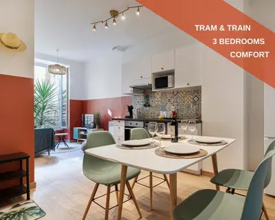 a dining room and kitchen with a table and chairs at Cosy and Trendy 3 Bedrooms train tramway in Nice