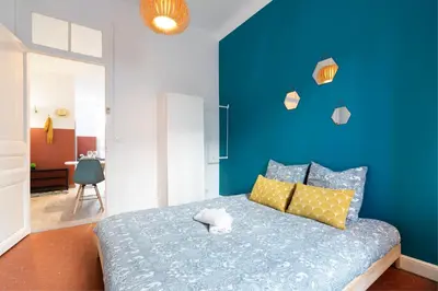a blue bedroom with a bed and a blue wall at Cosy and Trendy 3 Bedrooms train tramway in Nice