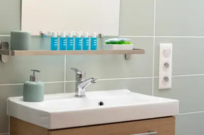 a bathroom with a white sink and a shelf at Cosy and Trendy 3 Bedrooms train tramway in Nice