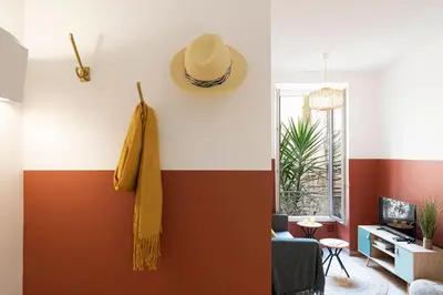 a living room with a hat on the wall at Cosy and Trendy 3 Bedrooms train tramway in Nice