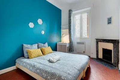 a blue bedroom with a bed and a fireplace at Cosy and Trendy 3 Bedrooms train tramway in Nice