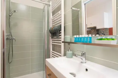 a bathroom with a sink and a shower at Cosy and Trendy 3 Bedrooms train tramway in Nice