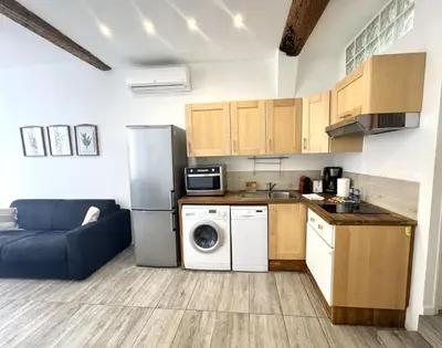 a kitchen with a refrigerator and a washing machine at ApartHotel Riviera - Barillerie 12 - Vieille Ville 1mn plage - Appartement 2 pieces AC in Nice
