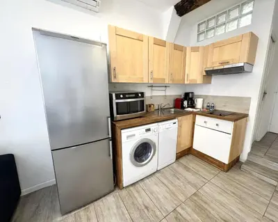 a kitchen with a refrigerator and a washing machine at ApartHotel Riviera - Barillerie 12 - Vieille Ville 1mn plage - Appartement 2 pieces AC in Nice