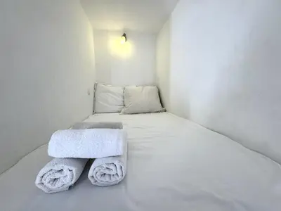 a small room with a bed with towels on it at ApartHotel Riviera - Barillerie 12 - Vieille Ville 1mn plage - Appartement 2 pieces AC in Nice
