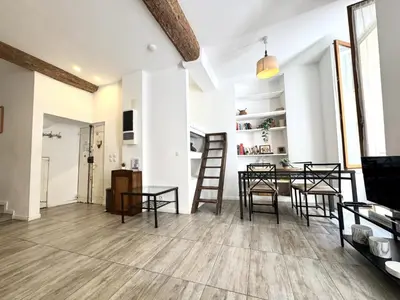 an open living room with a table and chairs at ApartHotel Riviera - Barillerie 12 - Vieille Ville 1mn plage - Appartement 2 pieces AC in Nice