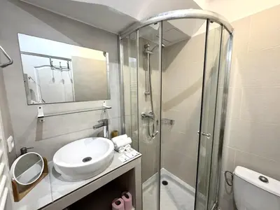 a bathroom with a sink and a glass shower at ApartHotel Riviera - Barillerie 12 - Vieille Ville 1mn plage - Appartement 2 pieces AC in Nice