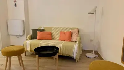 a couch with pillows on it in a room at ApartHotel Riviera - ISTRIA 1- Old town Promenade des Anglais - Superbe Appartement Superior 2 Pièces AC in Nice