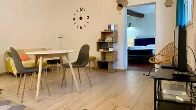 a living room with a table and chairs and a bedroom at ApartHotel Riviera - ISTRIA 1- Old town Promenade des Anglais - Superbe Appartement Superior 2 Pièces AC in Nice