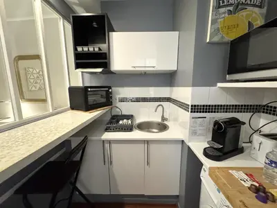 a small kitchen with a sink and a microwave at ApartHotel Riviera - VINCENT 1 - Vieille Ville - Appartement Supérieur 2 pieces AC in Nice
