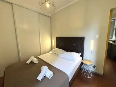 a bedroom with a bed with two towels on it at ApartHotel Riviera - VINCENT 1 - Vieille Ville - Appartement Supérieur 2 pieces AC in Nice