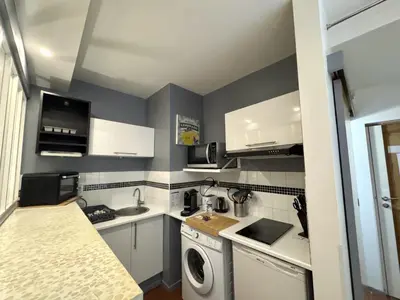 a small kitchen with a washing machine and a sink at ApartHotel Riviera - VINCENT 1 - Vieille Ville - Appartement Supérieur 2 pieces AC in Nice