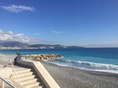a beach with stairs leading to the water at Nice Vue Mer 50m plage Parking in Nice