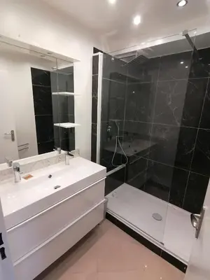 a bathroom with a white sink and a shower at Nice Vue Mer 50m plage Parking in Nice