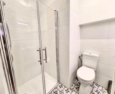 a bathroom with a toilet and a glass shower at ApartHotel Riviera - Maison de la Poissonnerie - Vieille Ville - Grand Appartement 3 piece AC - 5min de la Promenade des Anglais in Nice