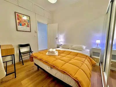 a bedroom with a large bed with a yellow blanket at ApartHotel Riviera - Maison de la Poissonnerie - Vieille Ville - Grand Appartement 3 piece AC - 5min de la Promenade des Anglais in Nice