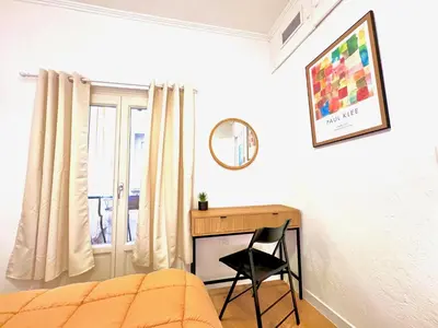 a bedroom with a desk and a bed and a chair at ApartHotel Riviera - Maison de la Poissonnerie - Vieille Ville - Grand Appartement 3 piece AC - 5min de la Promenade des Anglais in Nice