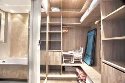 a bathroom with a tub and a table with a chair at Luxurious 2 Bedrooms Apartment, 30 meter from beach in Nice