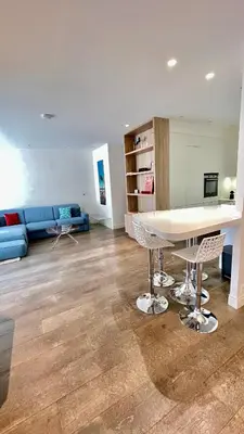 a living room with a table and a blue couch at Luxurious 2 Bedrooms Apartment, 30 meter from beach in Nice