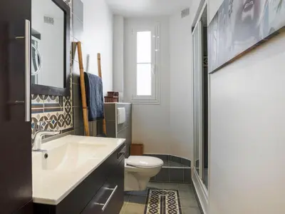 a bathroom with a white sink and a toilet at Apartment Le Paganini by Interhome in Nice
