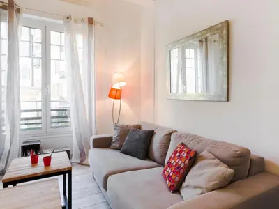 a living room with a couch and a table at Apartment Le Paganini by Interhome in Nice