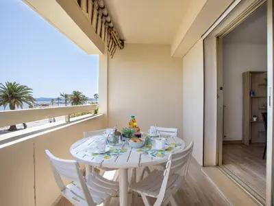 a dining room and living room with a table and chairs at Apartment Les Voiliers by Interhome in Saint-Laurent-du-Var