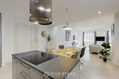 a kitchen and living room with a dining table at Grand Suite Promenade Five stars holiday house in Nice